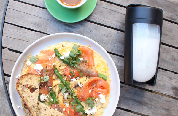 smoothies or meals whats better. Image of breakfast and a white smoothie in a mous fitness bottle
